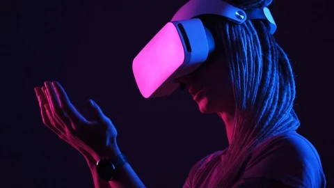 Lady in modern virtual reality glasses looks at hands Stock Footage 121316161