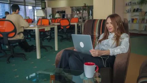 The lady in the office communicating by the Internet sourse Stock Photos