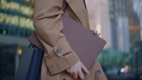 Lady office worker goes from work holding laptop in evening Video stock 164522934