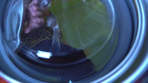 A lady opening the laundry machine glass door Stock Footage 93443284
