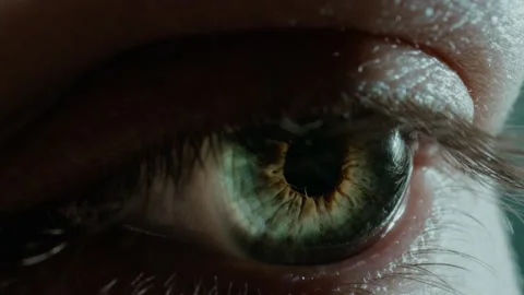 Lady opens eye with small pupil and colorful green iris Stock Footage 157328491