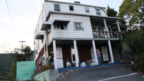 Lady outside abandoned house Stock Footage 77614276