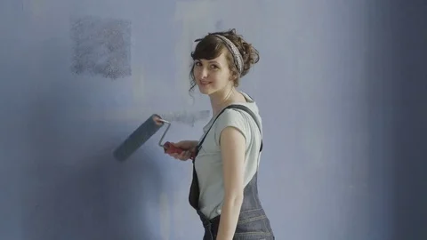 Lady paint wall with a roller Video stock 83870701