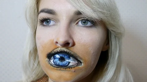 Lady with painted eye on lips Stock Footage 98707120