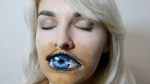 Lady with painted eye on lips Stock Footage 98707128