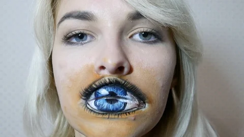 Lady with painted eye on lips Stock Footage 98707144