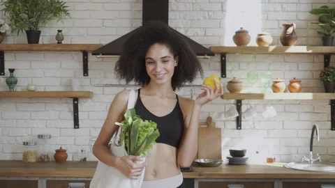 Lady with pepper in her hands promoting healthy eatting. Smilling and looking at Stock Footage 140864856