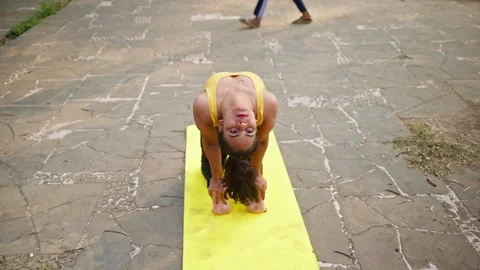Lady perform camel pose on mat in park Stock Footage 303128747