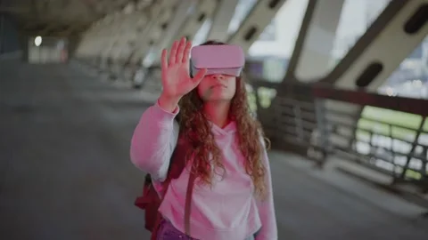 Lady at pink light goes under bridge and opens virtual door Stock Footage 164523237