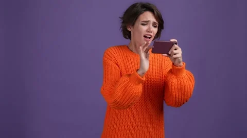 Lady play device game lose disappointed isolated dark bright color background Video stock 169361325