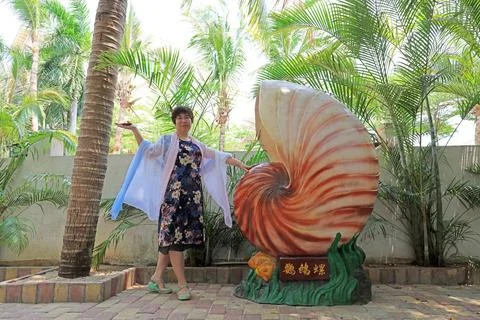 A lady play in front of huge conch sculptures, Sanya City, Hainan Province,.. Stock Photos