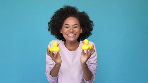 Lady play two yellow plastic ducks kiss date isolated blue color background Video stock 167358175