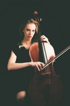 Lady Playing a Song on Cello, Looking at Camera Stock Photos