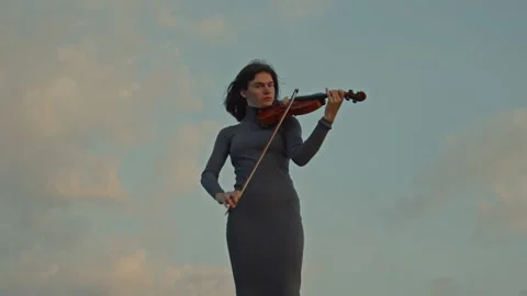 Lady Playing Violin On Sky Background Stock Footage 164393912