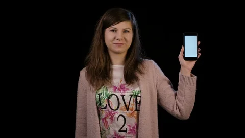 A Lady Pointing to a Phone with a White Screen Stock Footage 86592167