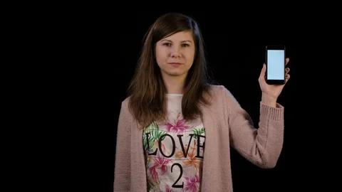 A Lady Pointing to a Phone with a White Screen Stock Footage 86592375