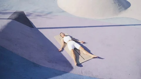 Lady practicing Dead Body Corpse Pose ,Shavasana Stock Footage 260335087
