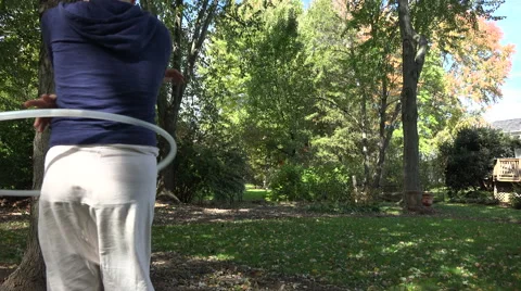 Lady Practicing Hula Hoop in Yard 스톡 동영상 43011755