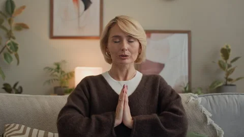 Lady Practicing Prayer Pose while Meditating with Laptop in Living Room Stock Footage 330114305