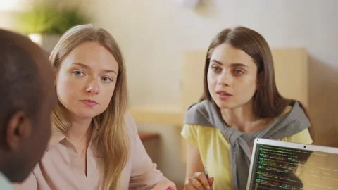 Lady presenting code to focused colleagues Video stock 142543493