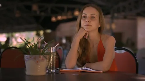 Lady Props up Chin with Hand at Cafe Table Listens Stock Footage 88468977