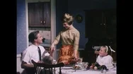 Lady Puts Roast Dinner On The Table For Her Family Stock Footage