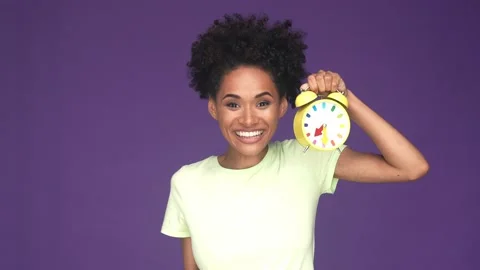 Lady raise hands clock celebrate success isolated purple color background Stock Footage 165878281