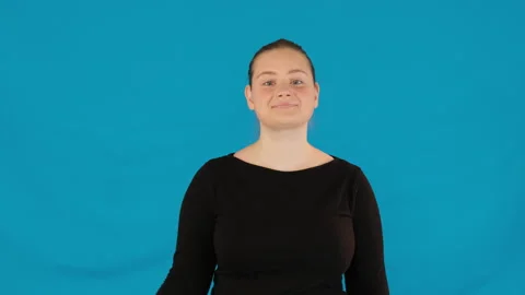 Lady raises hand making OK gesture on blue background Stock-Footage 316046865