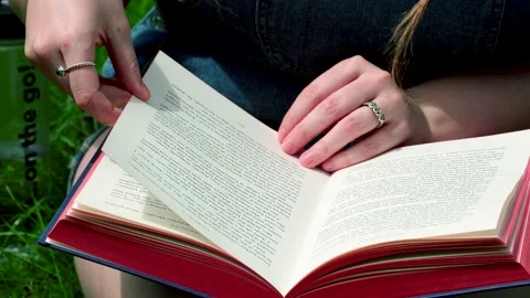 Lady reading a book outdoors Stock Footage 134896524