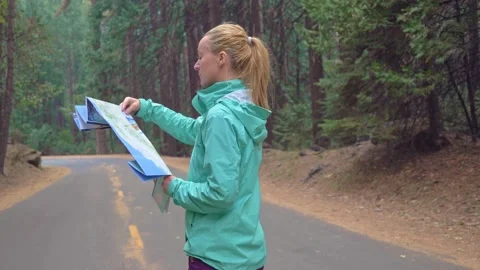 Lady reading tourist map handheld shot female woman girl body chest belly bust Stock Footage 131389563