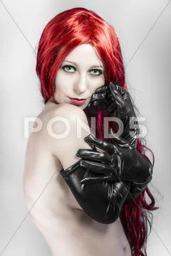 Lady in red wearing large black gloves, nude woman Stock Photos
