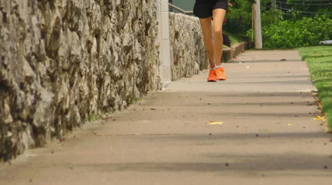 A Lady Running on a Sidewalk Stock Footage 50035655