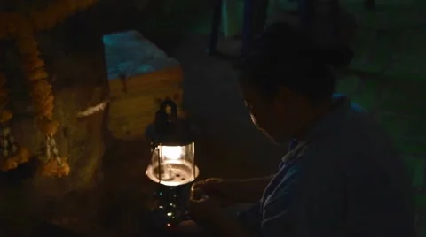 Lady setting up a heat lamp in the cave Stock Footage 62851216