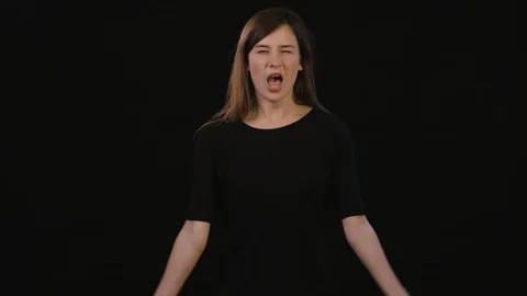 A Lady Shouting Against a Black Background Stock Footage 87163244