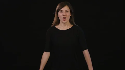 A Lady Shouting Against a Black Background Stock Footage 87163358