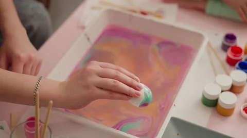 Lady shows Easter egg with abstract pattern of Ebru art Stock Footage 172542087