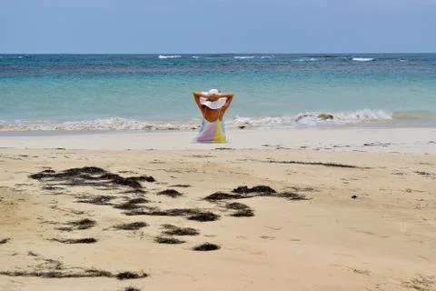 Lady sitting on the beach Stock Photos