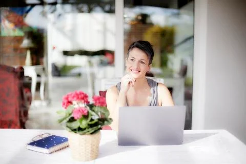 Lady smiling and thinking working with the laptop Stock Photos
