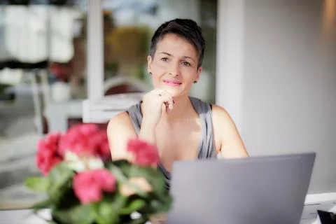 Lady smiling and thinking working with the laptop Stock Photos