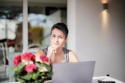 Lady smiling and thinking working with the laptop Stock Photos