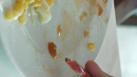 Lady is squeezing out the ketchup from mini packet Stock Footage 91187329