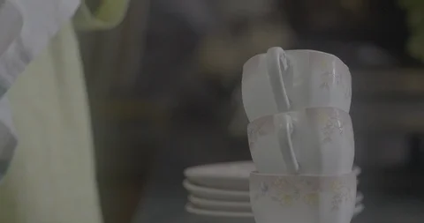 Lady stacking cups one above the other Shot on Sony FS7 Stock-Footage 90900137