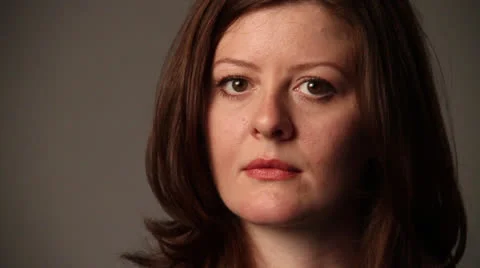 Lady standing in front of the camera and smiles suddenly Stock Footage 22934696