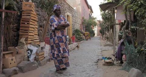 A lady standing in front of her shop, Goree, Senegal (4K) Stock Footage 47945189