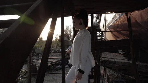 Lady stands half face on ground against ship and sunshine Stock Footage 117888469