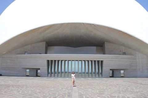 Lady stands on a modern architectural facade Stock Photos