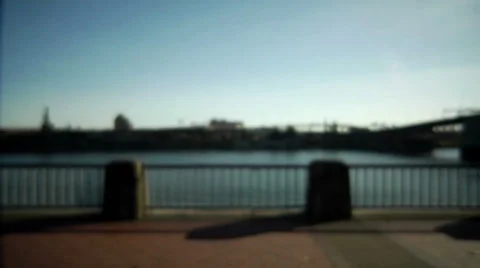 A  lady stares off into space while she stands with her back to the river Stock Footage 33992260