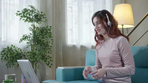 Lady Student Learning Using Computer Webcam Chat Makes Notes. Distance education Video stock 162852431