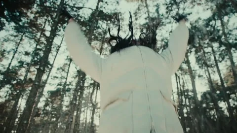 Lady with sunglasses in jacket throws snow in winter forest Stock Footage 147741409