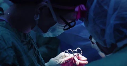 Lady Surgeons collaborating  performing a masectomy Stock Footage 146164376